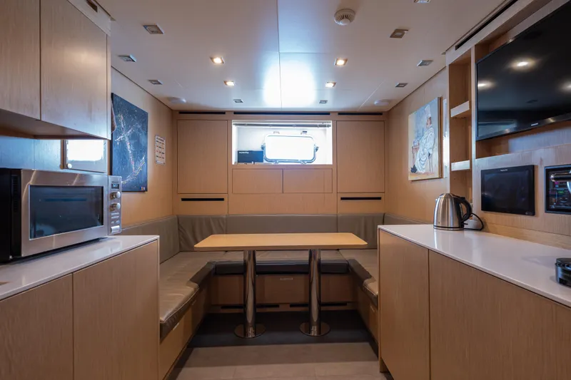 Sofi VI Yacht Photos Pics Luxurious interior of 2023 Sanlorenzo SL120A yacht with modern kitchen and dining area.