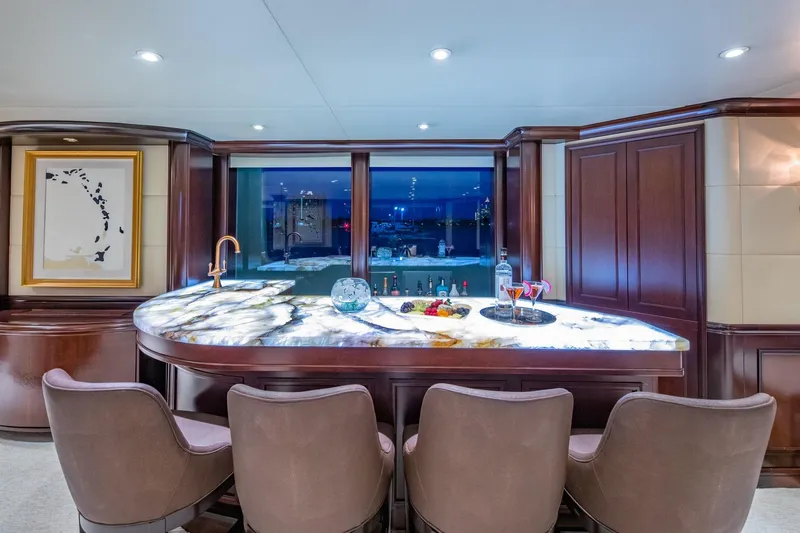 Starship Yacht Photos Pics Luxurious bar area on 1986 Van Mill 144 Motor Yacht with elegant seating and marble countertop.