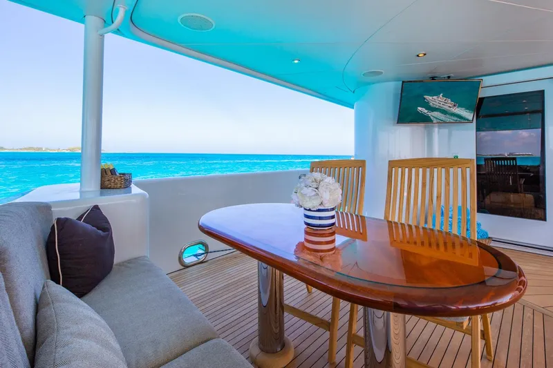 Starship Yacht Photos Pics Luxurious deck of 1986 Van Mill 144 Motor Yacht with ocean view and elegant seating.