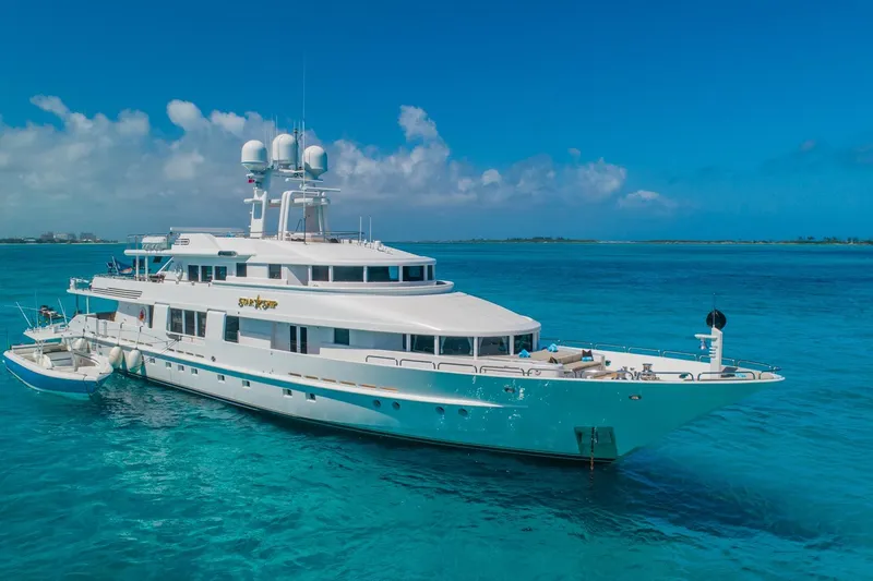 Starship Yacht Photos Pics Luxurious 1986 Van Mill 144 Motor Yacht on turquoise ocean waters under clear blue sky.