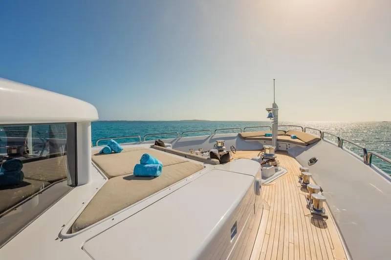 Starship Yacht Photos Pics Luxurious 1986 Van Mill 144 Motor Yacht deck with sun loungers and ocean view.