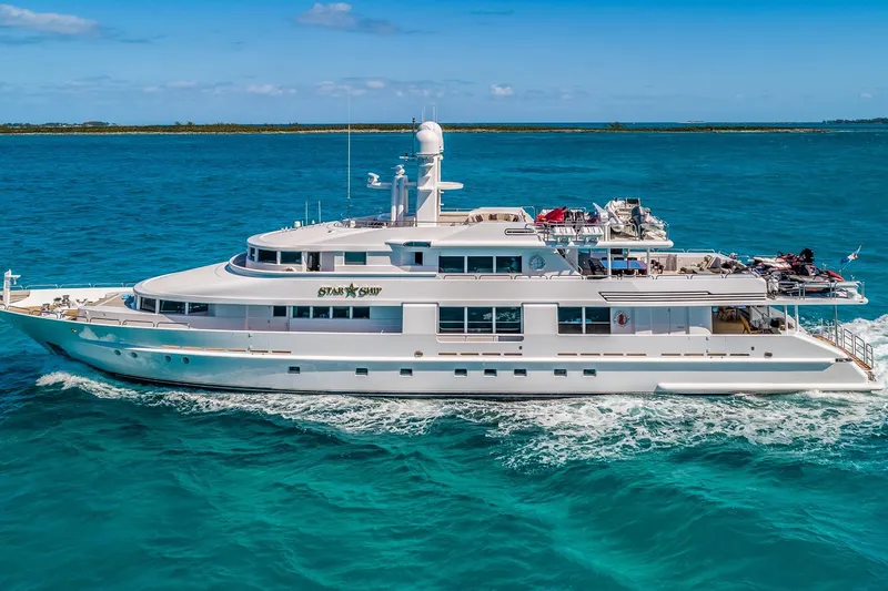 Starship Yacht Photos Pics Luxurious 1986 Van Mill 144 Motor Yacht cruising on clear blue waters.