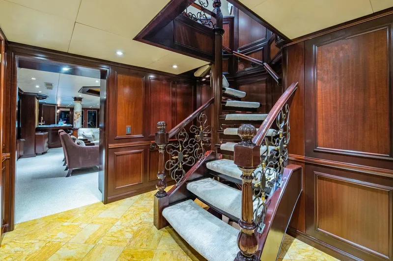 Starship Yacht Photos Pics Luxurious interior of 1986 Van Mill 144 Motor Yacht with elegant staircase and wood paneling.