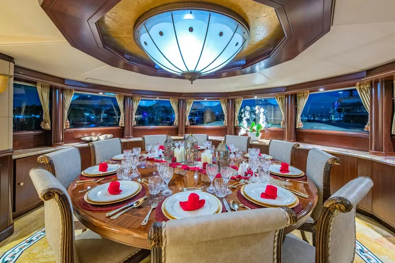 Starship Yacht Photos Pics Luxurious dining area on 1986 Van Mill 144 Motor Yacht, elegantly set table, panoramic windows.