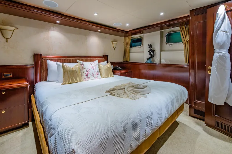 Starship Yacht Photos Pics Luxurious bedroom interior of 1986 Van Mill 144 Motor Yacht with elegant wood paneling.