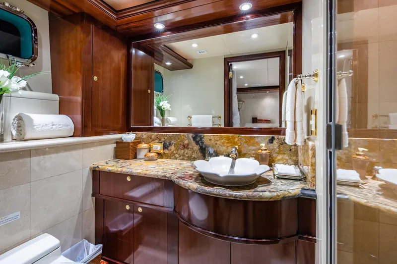 Starship Yacht Photos Pics Luxurious bathroom on 1986 Van Mill 144 Motor Yacht with elegant wood and marble finishes.