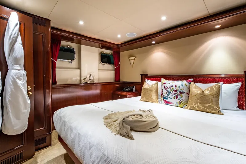 Starship Yacht Photos Pics Luxurious bedroom interior on 1986 Van Mill 144 Motor Yacht with elegant decor and plush bedding.