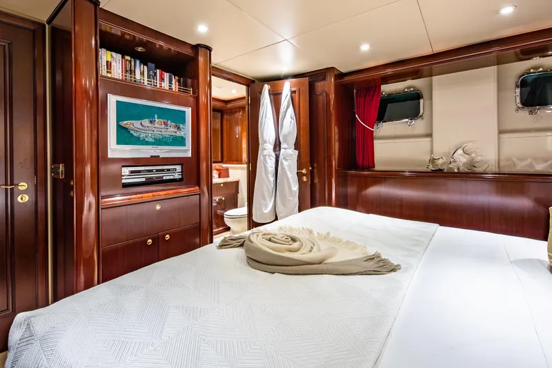 Starship Yacht Photos Pics Luxurious 1986 Van Mill 144 Motor Yacht bedroom with elegant wood paneling and modern amenities.