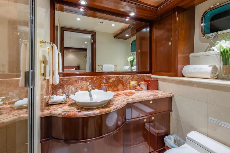 Starship Yacht Photos Pics Luxurious bathroom on 1986 Van Mill 144 Motor Yacht with marble countertop and elegant fixtures.