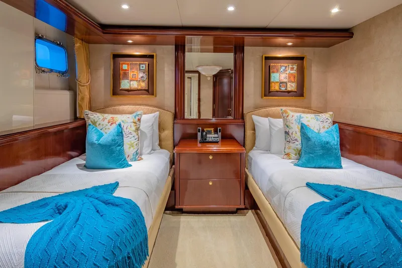 Starship Yacht Photos Pics Luxurious twin cabin on 1986 Van Mill 144 Motor Yacht with elegant decor and vibrant accents.