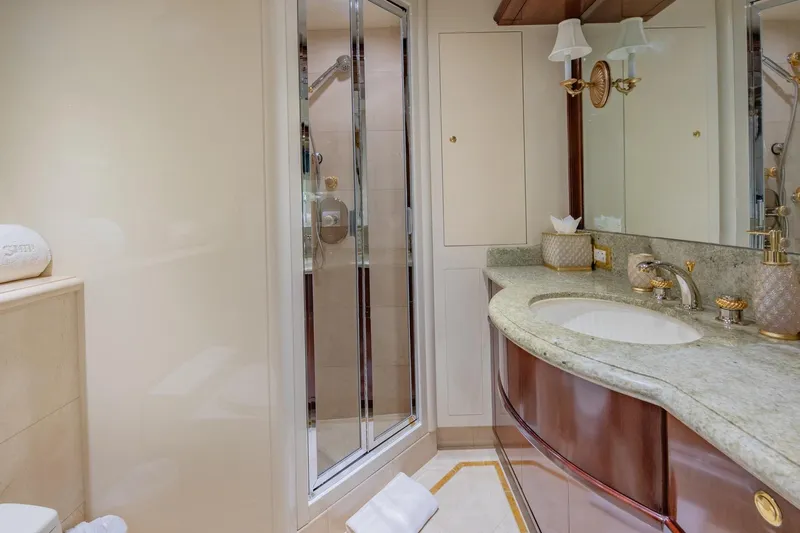 Starship Yacht Photos Pics Luxurious bathroom on 1986 Van Mill 144 Motor Yacht with elegant fixtures and marble countertop.