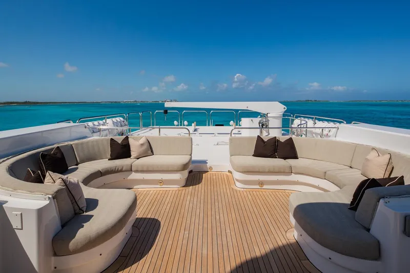 Starship Yacht Photos Pics Luxurious deck seating on 1986 Van Mill 144 Motor Yacht, overlooking turquoise ocean waters.