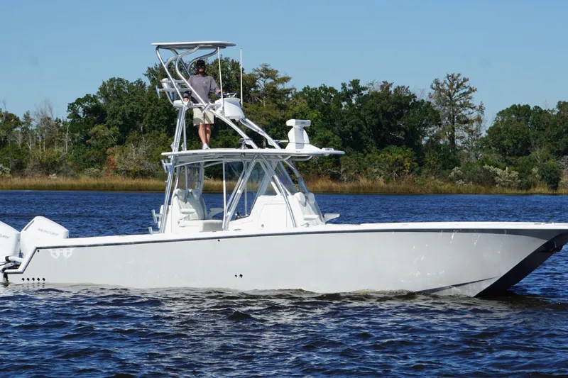  Yacht Photos Pics 2020 Custom HHH 35LX Catamaran cruising on a calm river with lush green trees.