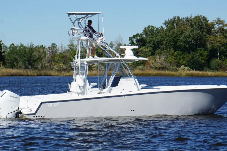  Yacht Photos Pics Custom HHH 35LX Catamaran 2020 cruising on a calm river with lush green trees.