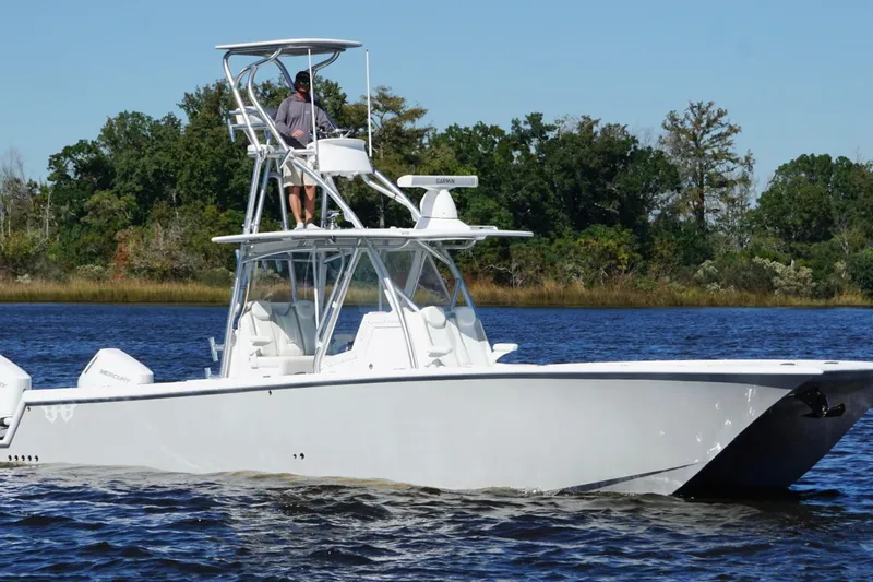  Yacht Photos Pics 2020 Custom HHH 35LX Catamaran cruising on a lake with lush green trees in the background.