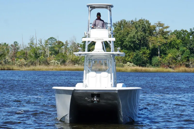  Yacht Photos Pics 2020 Custom HHH 35LX Catamaran on water, with lush green shoreline background.