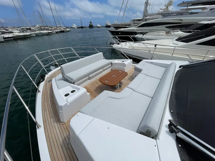 Melita Yacht Photos Pics Luxurious Azimut 60 Flybridge 2023 yacht with spacious deck seating in a marina.