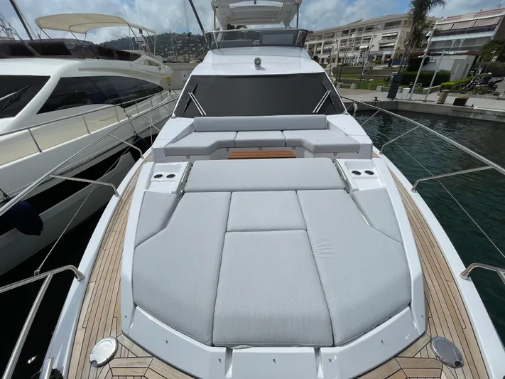 Melita Yacht Photos Pics Azimut 60 Flybridge 2023 yacht with spacious sunbathing area, docked at marina.