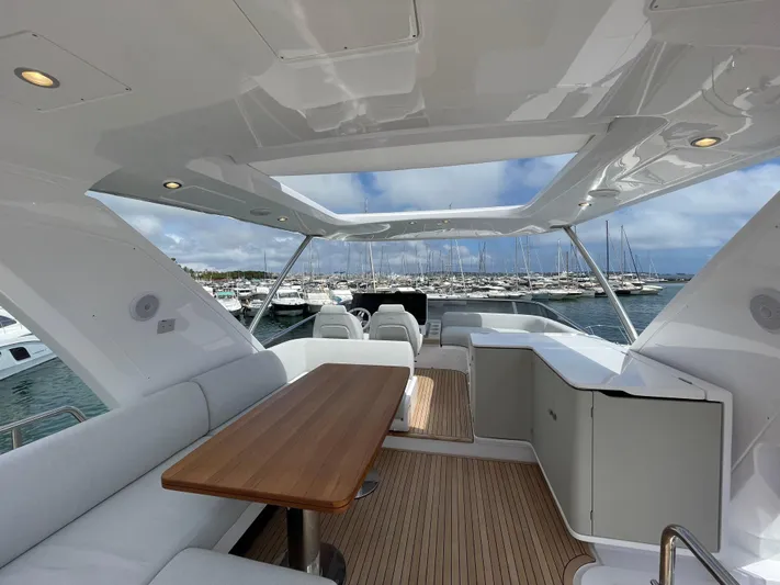 Melita Yacht Photos Pics Luxurious Azimut 60 Flybridge 2023 yacht interior with elegant seating and wooden table.