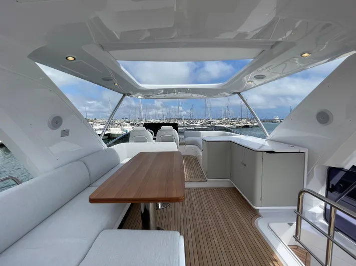 Melita Yacht Photos Pics Azimut 60 Flybridge 2023 yacht interior with seating, table, and marina view.