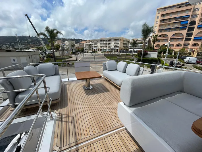 Melita Yacht Photos Pics Luxurious Azimut 60 Flybridge 2023 yacht deck with elegant seating and scenic marina view.