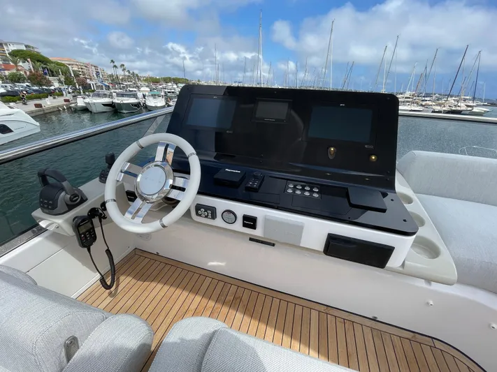 Melita Yacht Photos Pics Flybridge helm of Azimut 60, 2023 model, with modern controls and marina view.