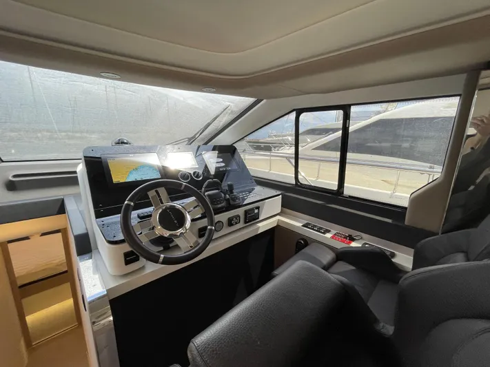 Melita Yacht Photos Pics Interior helm of 2023 Azimut 60 Flybridge yacht, featuring modern controls and navigation equipment.