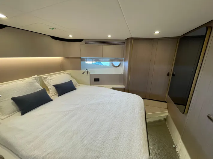 Melita Yacht Photos Pics Luxurious bedroom interior of Azimut 60 Flybridge 2023 yacht, featuring modern design and cozy ambiance.