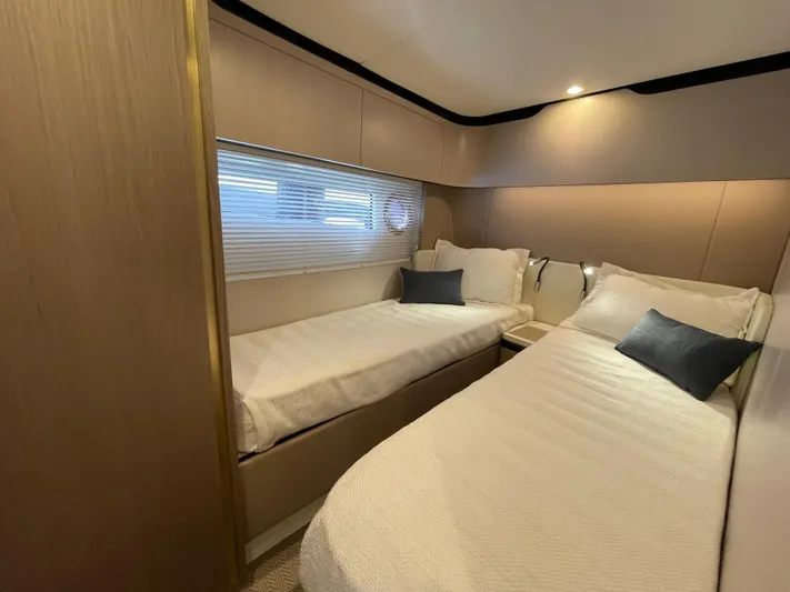 Melita Yacht Photos Pics Luxurious twin bedroom in 2023 Azimut 60 Flybridge yacht, featuring modern design and cozy bedding.