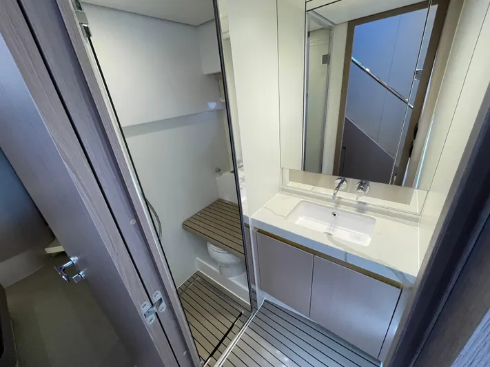 Melita Yacht Photos Pics Modern bathroom in Azimut 60 Flybridge 2023 yacht, featuring sleek design and wooden flooring.