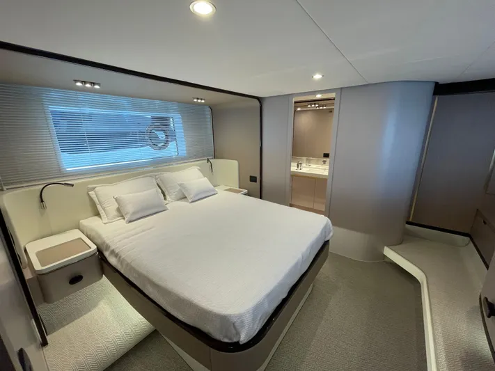 Melita Yacht Photos Pics Luxurious bedroom interior of Azimut 60 Flybridge 2023 yacht, featuring modern design and elegant furnishings.