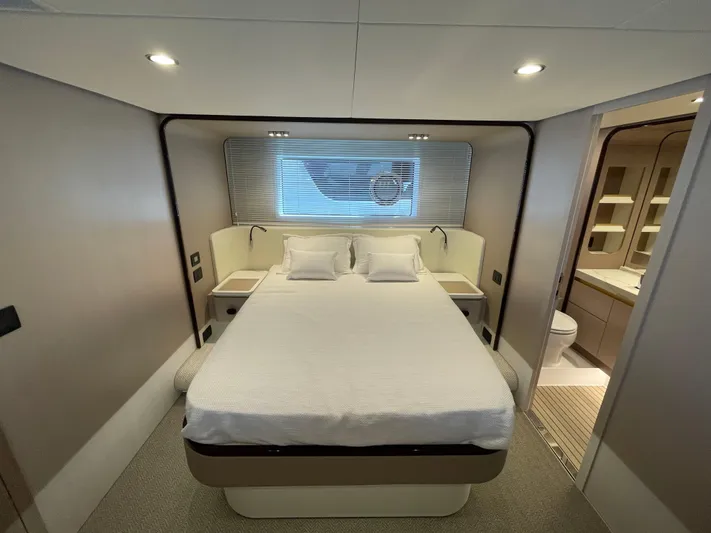 Melita Yacht Photos Pics Luxurious bedroom in Azimut 60 Flybridge 2023 yacht, featuring modern design and ensuite bathroom.