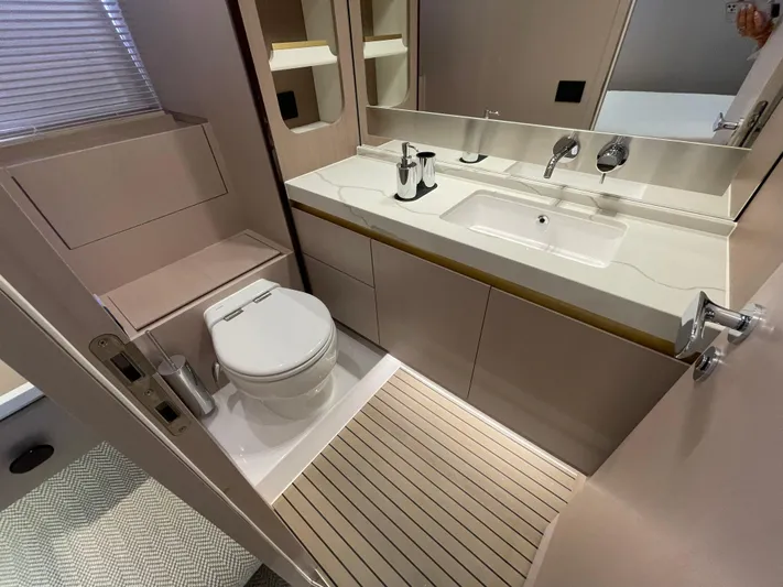 Melita Yacht Photos Pics Modern bathroom in 2023 Azimut 60 Flybridge yacht with sleek fixtures and wooden flooring.