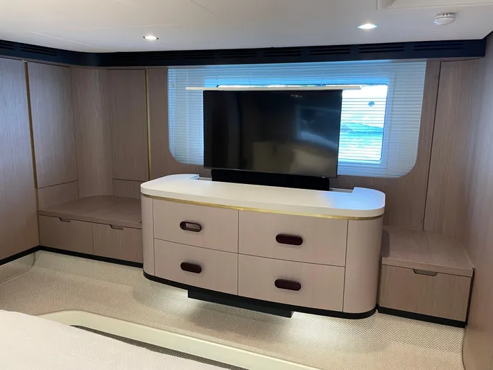 Melita Yacht Photos Pics Luxurious interior of 2023 Azimut 60 Flybridge yacht with modern TV and cabinetry.