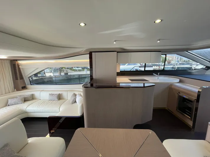 Melita Yacht Photos Pics Luxurious interior of 2023 Azimut 60 Flybridge yacht with modern furnishings and panoramic windows.