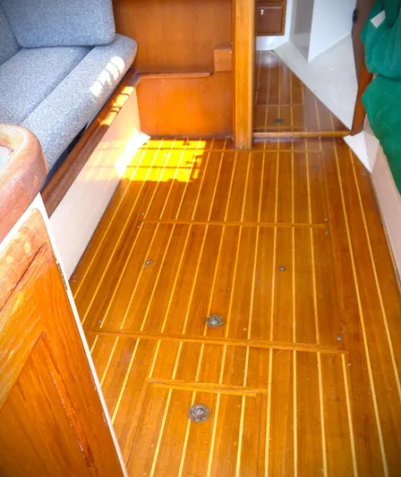 Scout Yacht Photos Pics Interior of 1998 Pacific Seacraft 34 sailboat with polished wooden flooring and seating.