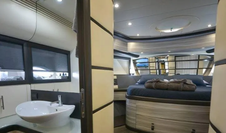 Charme Yacht Photos Pics Luxurious interior of a 2004 Pershing 76 yacht with modern bedroom and bathroom.