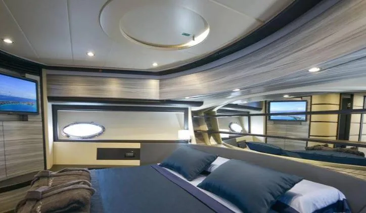 Charme Yacht Photos Pics Luxurious bedroom interior of 2004 Pershing 76 yacht with modern design and ambient lighting.