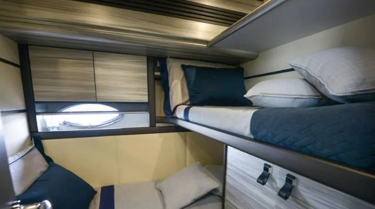 Charme Yacht Photos Pics Bunk beds in a 2004 Pershing 76 yacht cabin, featuring modern design and cozy bedding.