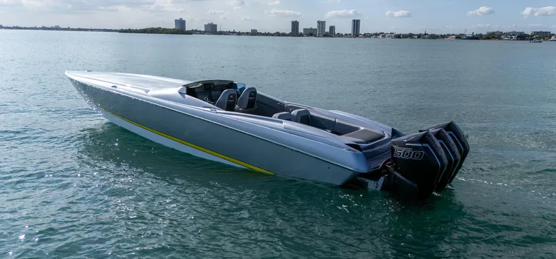  Yacht Photos Pics 2017 Nor-Tech 3900 Super-VEE speedboat on calm water with city skyline background.