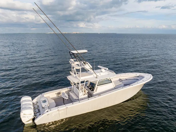 Yacht Photos Pics 2022 Yellowfin 42 boat on open water with triple outboard engines.