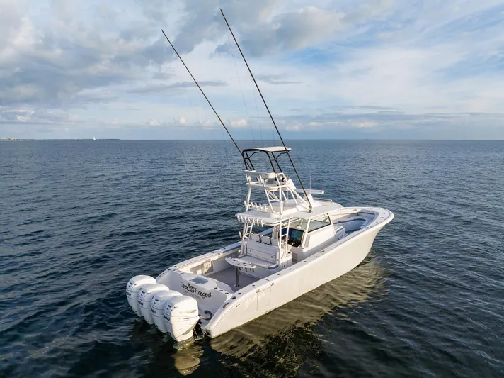  Yacht Photos Pics 2022 Yellowfin 42 boat with triple outboard engines on open water.