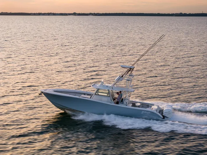  Yacht Photos Pics 2022 Yellowfin 42 boat cruising on open water at sunset.