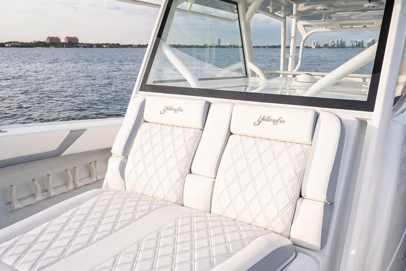  Yacht Photos Pics 2022 Yellowfin 42 boat with luxurious white seating on a calm water backdrop.