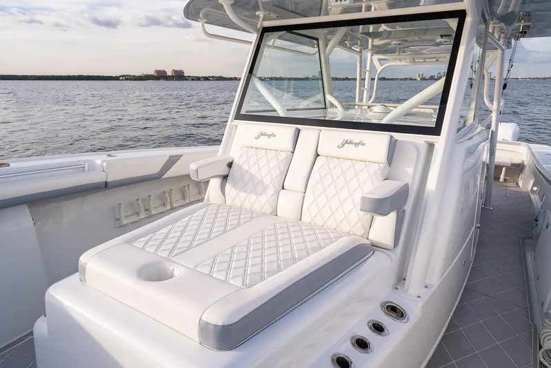  Yacht Photos Pics 2022 Yellowfin 42 boat with luxurious white seating on a calm water backdrop.