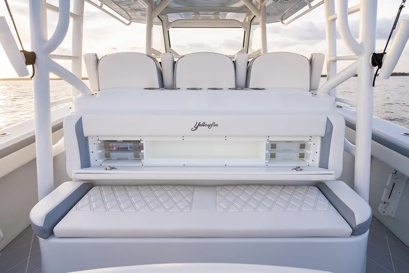 Yacht Photos Pics 2022 Yellowfin 42 boat interior with white cushioned seating and storage compartments.