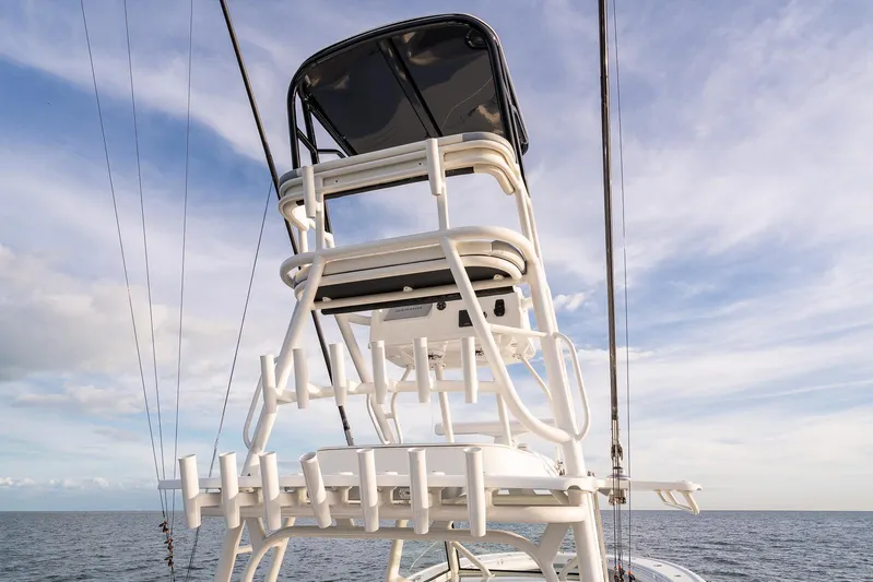  Yacht Photos Pics 2022 Yellowfin 42 boat tower with rod holders against a blue sky.