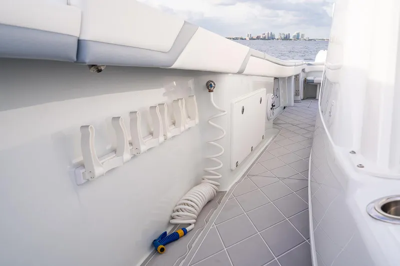  Yacht Photos Pics 2022 Yellowfin 42 boat deck with rod holders and coiled hose.