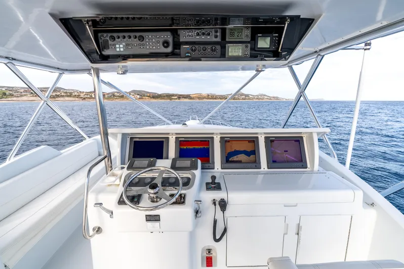 Determined Yacht Photos Pics Helm of 2003 Hatteras 60 Convertible yacht with navigation equipment and ocean view.