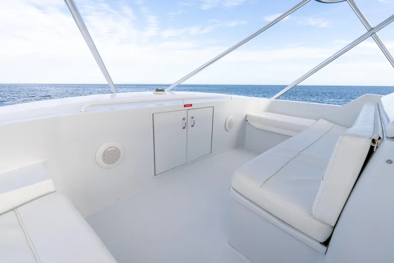 Determined Yacht Photos Pics 2003 Hatteras 60 Convertible yacht interior with white seating and ocean view.